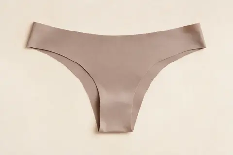 Culotte bikini VOENXE en microfibre présentée à plat sur un fond ivoire lumineux
